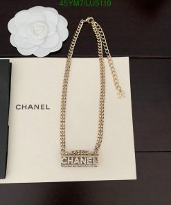 Gold chain necklace on branded box with flower decor.