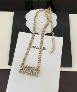 Gold chain necklace with logo pendant on display.