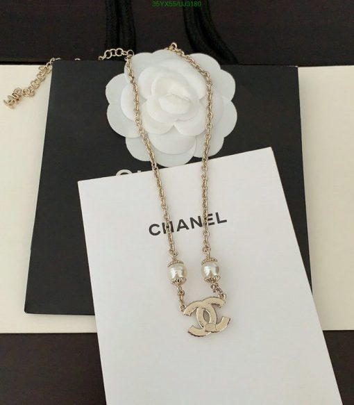 Designer necklace on branded display.