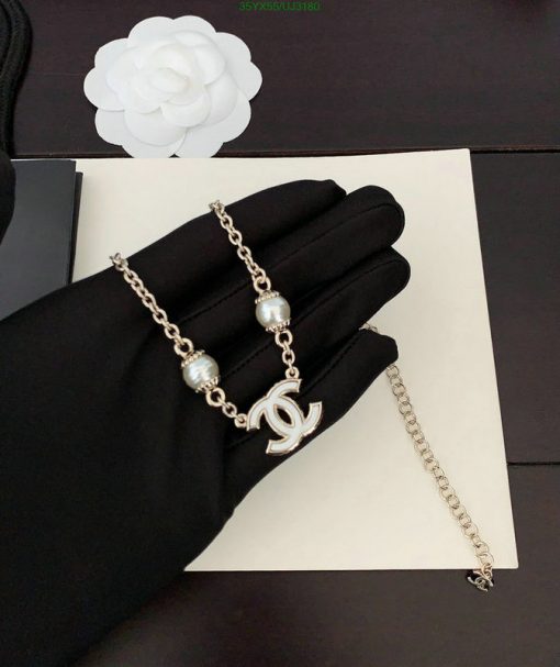 Elegant pearl bracelet displayed on black glove.