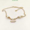 Gold chain bracelet with logo and pearl details.