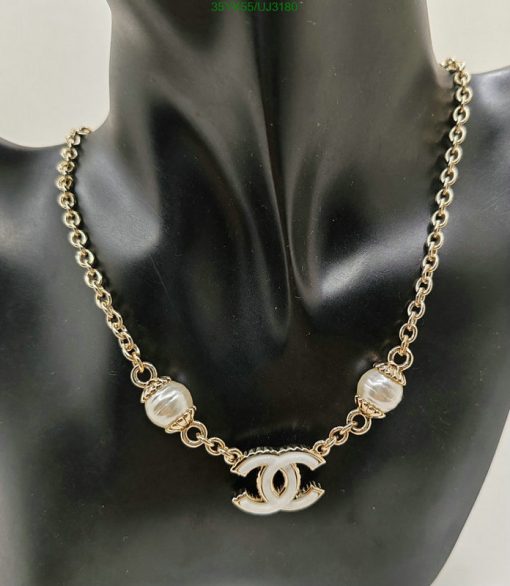 Gold chain necklace with pearls on mannequin.