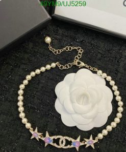 Elegant pearl bracelet with gold accents and flower charm.