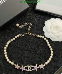 Elegant pearl bracelet with gold charm details.