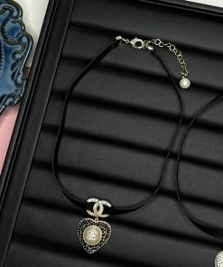 Black velvet choker with pearl pendant in jewelry box.