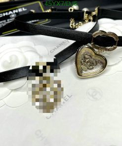 Chanel branded heart pendant and black leather necklace.