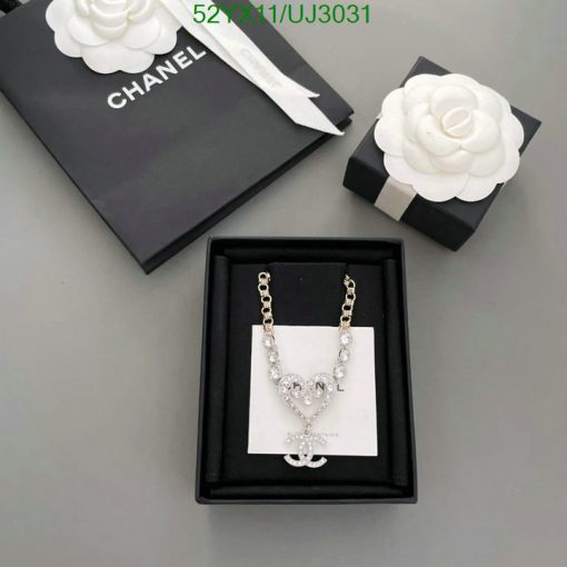 Chanel necklace with packaging on gray background