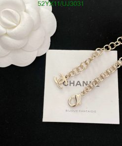 Silver bracelet with logo on white card.