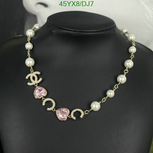 Pearl necklace with decorative elements on display mannequin.