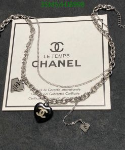 Chanel necklace with certificate on gray background.