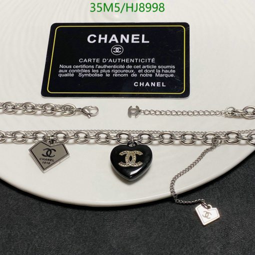 Chanel jewelry and authenticity card on white background