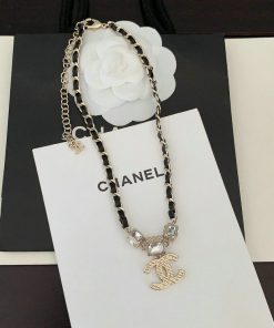 Designer necklace on branded display card.