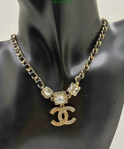 Gold chain necklace with pendant on mannequin.