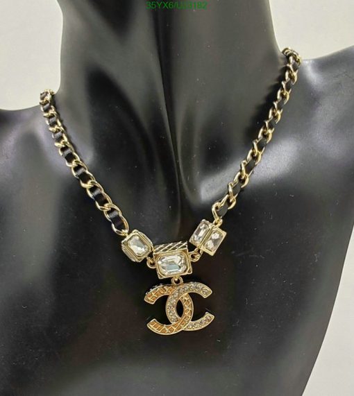 Gold chain necklace with pendant on mannequin.