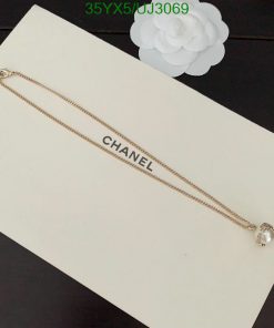 Gold chain bracelet with brand logo on display.