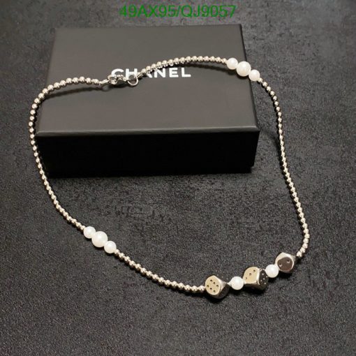 Elegant pearl and bead designer necklace on black box.