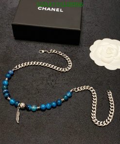 Blue beaded necklace with silver chain and packaging.