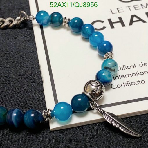 Blue beaded bracelet with feather charm and certificate.