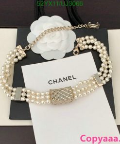 Pearl and gold-tone designer bracelet on display.