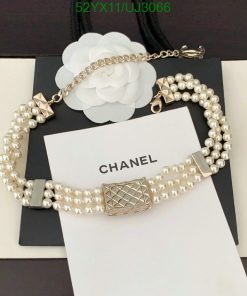 Elegant pearl designer bracelet on display with packaging.