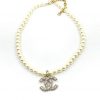 Pearl necklace with anchor pendant on white.