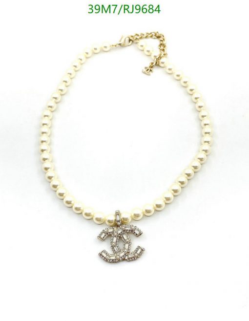 Pearl necklace with anchor pendant on white.