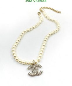 Pearl necklace with anchor pendant on white background.