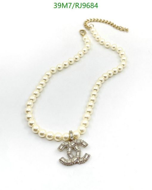 Pearl necklace with anchor pendant on white background.