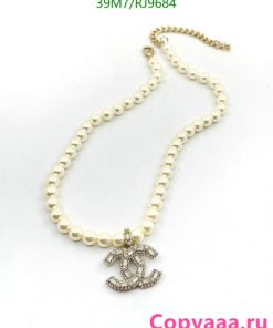 Pearl necklace with anchor pendant on white background.