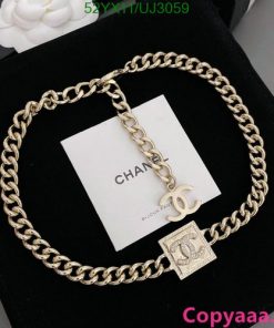 Gold Chanel logo chain necklace on display.