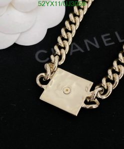 Gold chain necklace with designer clasp detail.