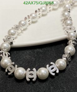 Pearl necklace with silver interlocking logo design elements.