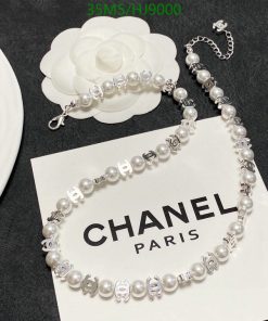 Pearl bracelet with logo charms on Chanel card.