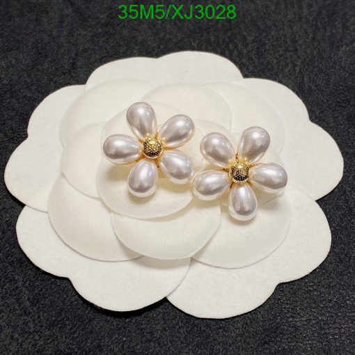 Pearl flower earrings on white display.