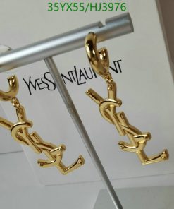 Gold designer logo earrings on display stand