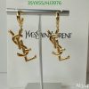 Gold designer logo earrings display.