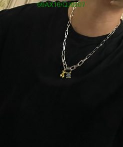 Person wearing pendant on silver chain necklace.