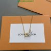 Gold necklace with pendant on branded box.