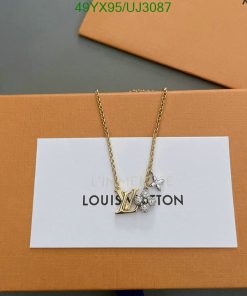 Gold necklace with pendant on branded box.