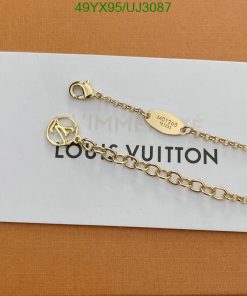 Gold Louis Vuitton chain on paper.