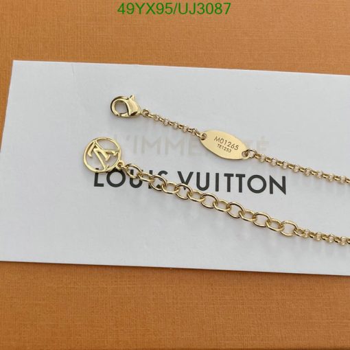 Gold Louis Vuitton chain on paper.