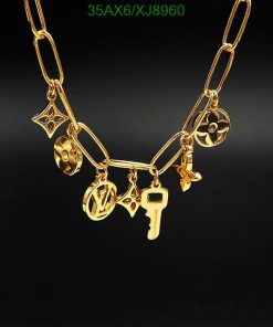 Gold charm necklace on a black background.