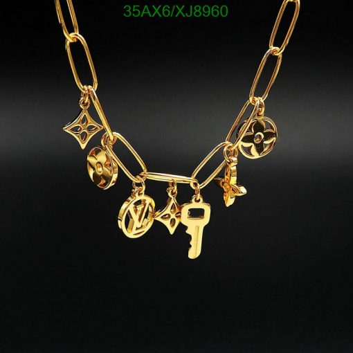 Gold charm necklace on a black background.