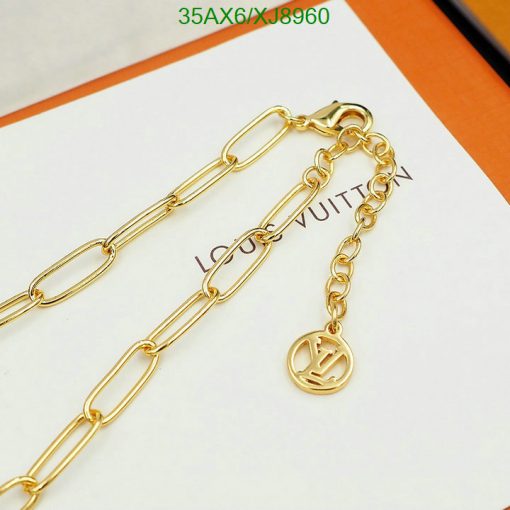 Gold chain with designer logo charm.