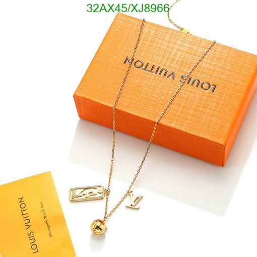 Designer necklace with pendant on branded orange box.