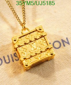 Gold pendant on branded fabric background.