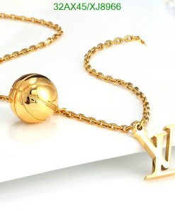 Gold necklace with spherical pendant and letter charm.