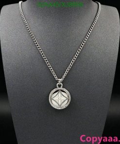 Silver pendant necklace on black display.