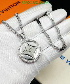 Silver pendant necklace on white gloved hand.