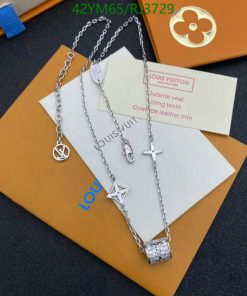 Designer silver necklaces on branded packaging.